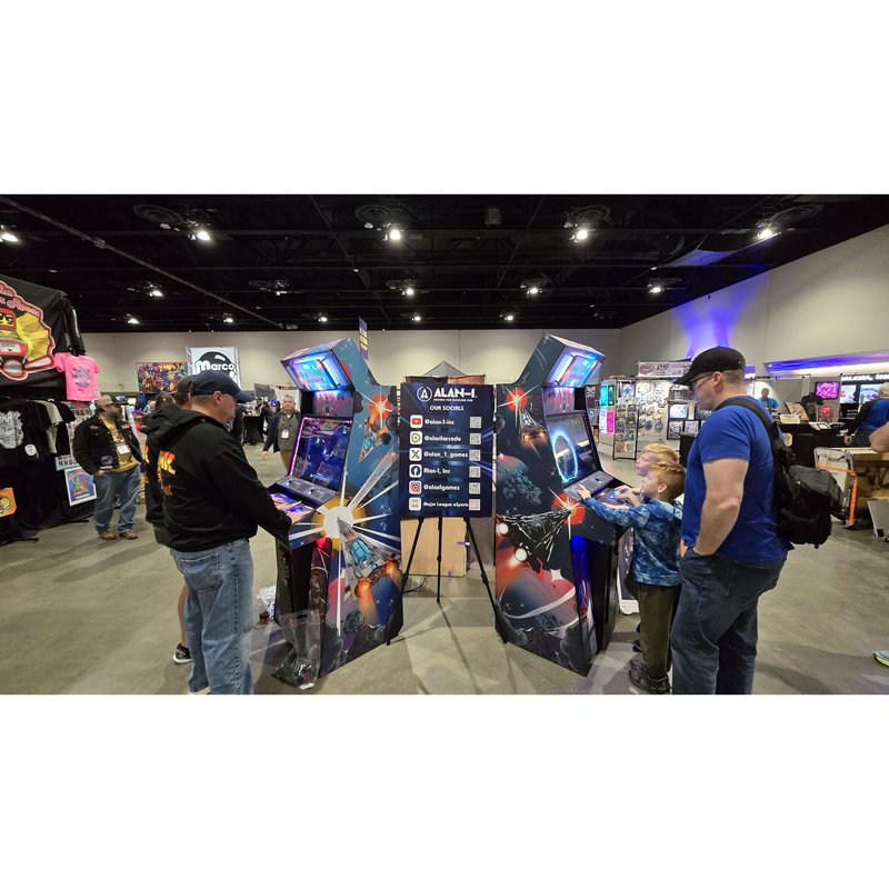 Two Atari Asteroids Recharged arcade cabinets by Alan-1 being played at the manufacturer's booth during Pinball Expo 2024.