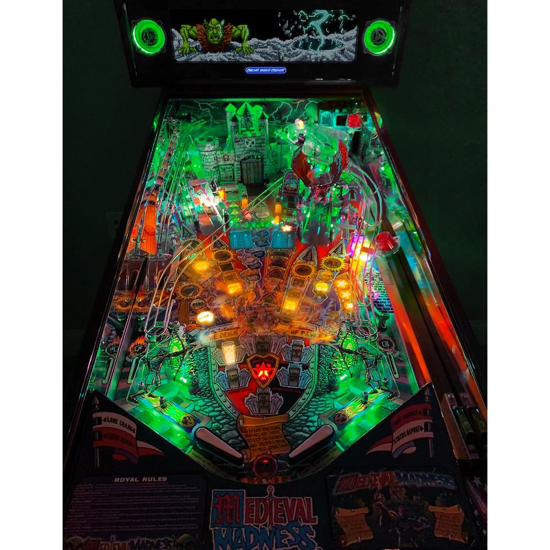 Chicago Gaming Medieval Madness Remake Merlin Edition home pinball machine, overhead playfield view showing lit bumpers, ramps, and castle target image