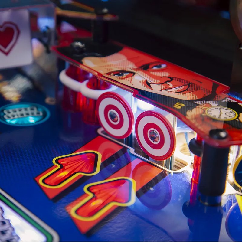 Chicago Gaming Pulp Fiction pinball machine commercial coin-operated game showing illuminated playfield with flippers and target bumpers in close-up detail image