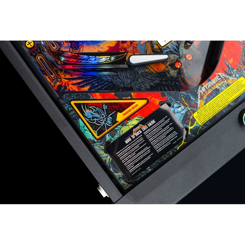 Stern Metallica Remastered Premium pinball machine playfield with instruction card showing game rules and features overview.