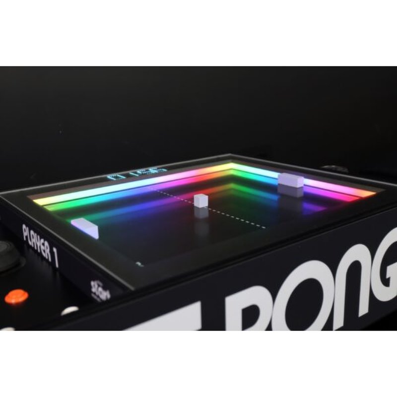 Atari PONG Mechanical Table Home Edition, close-up angled view of playfield corner: paddles, puck, RGB border, Player 1 label.