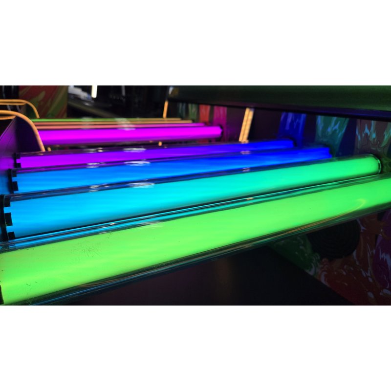 Alan-1 Soda Slam Arcade Redemption Game, close up of the RGB LED fill up tubes lit across magenta, blue, cyan and green, the lighting effect that runs along the control deck and reacts when a tap is pulled.