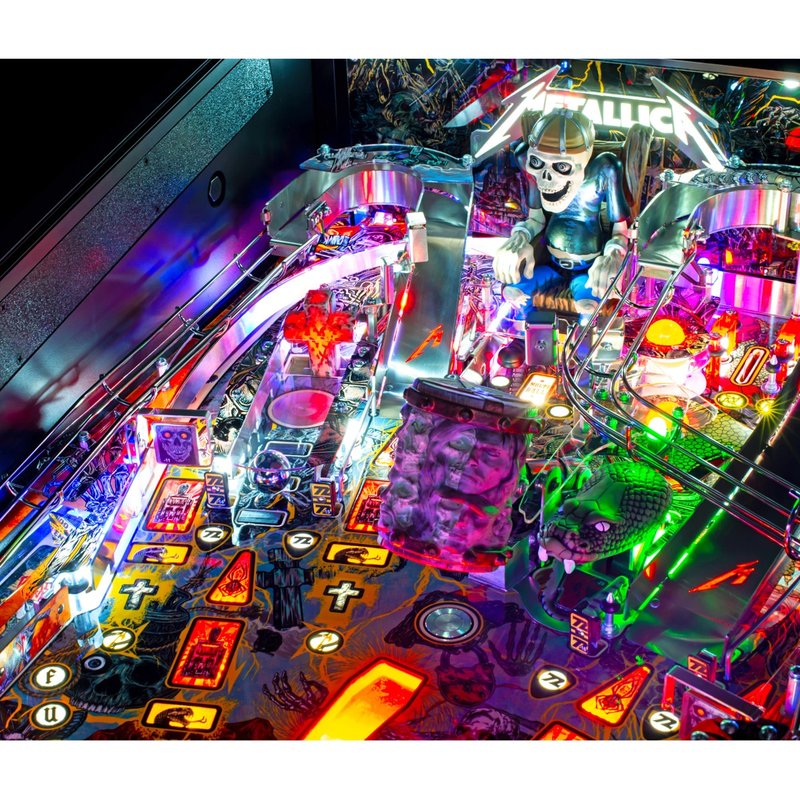 Stern Metallica Remastered Premium Pinball Machine playfield overview showing illuminated targets, ramps, bumpers, and Sparky figure.